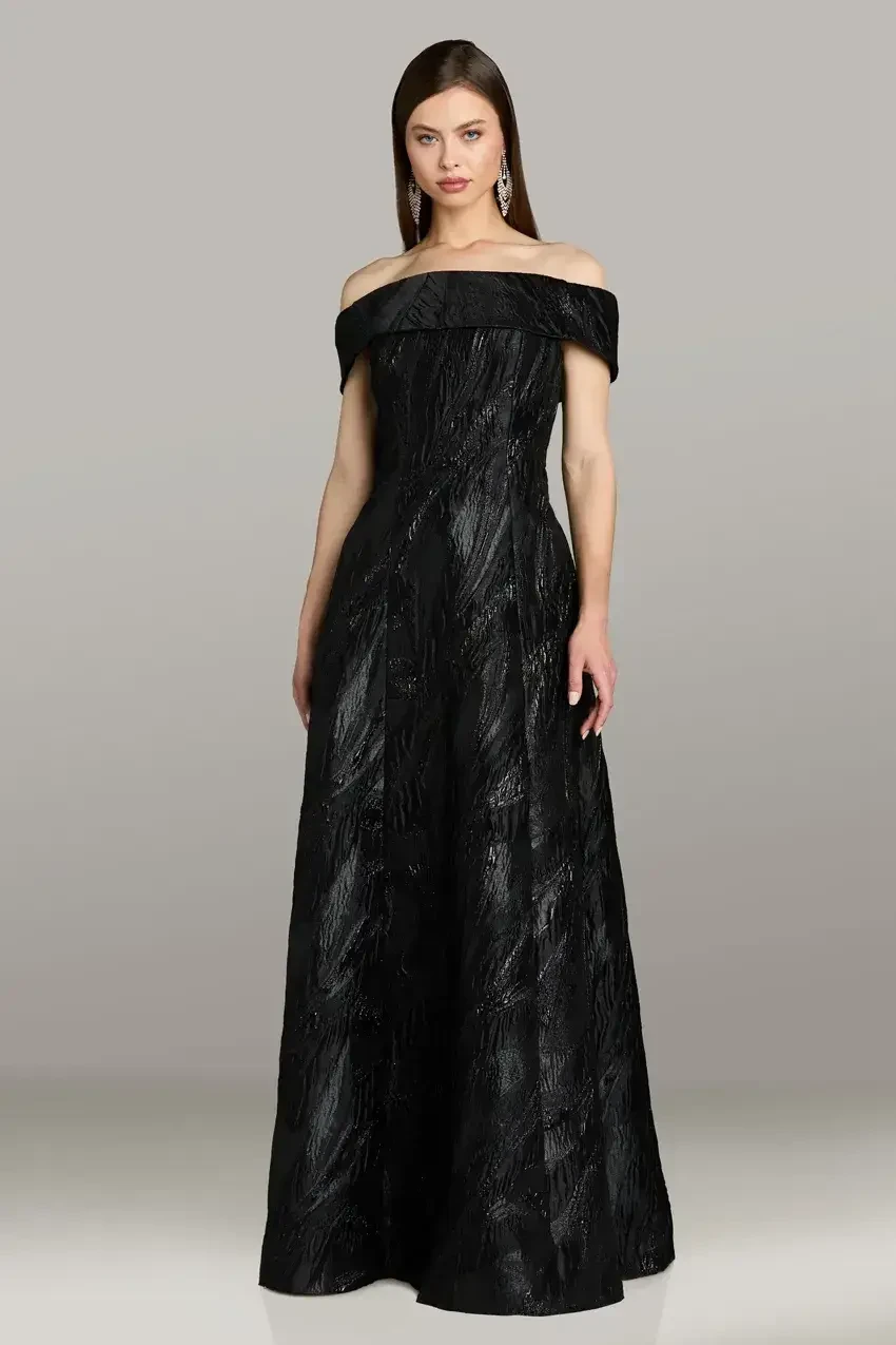 A woman in a black off-the-shoulder evening gown.