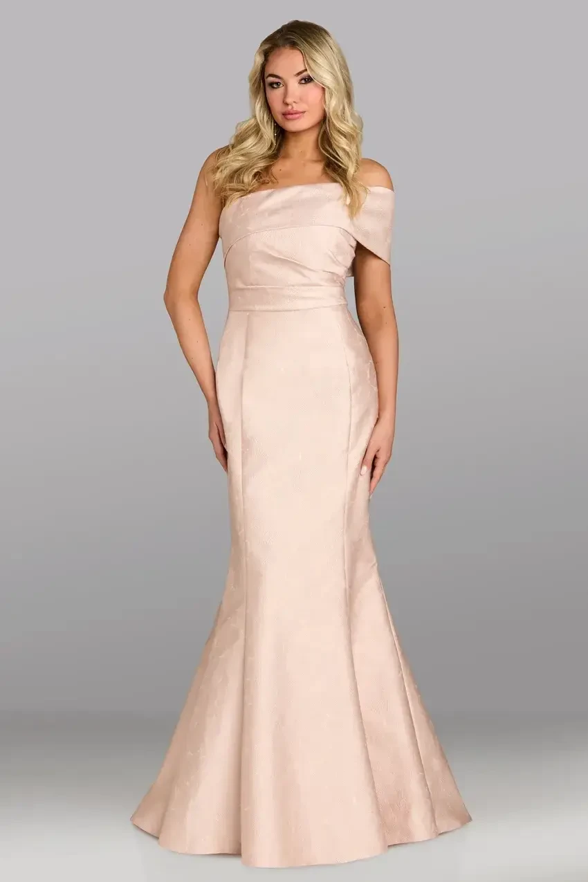 A woman wearing an elegant, off-the-shoulder, floor-length blush pink dress.